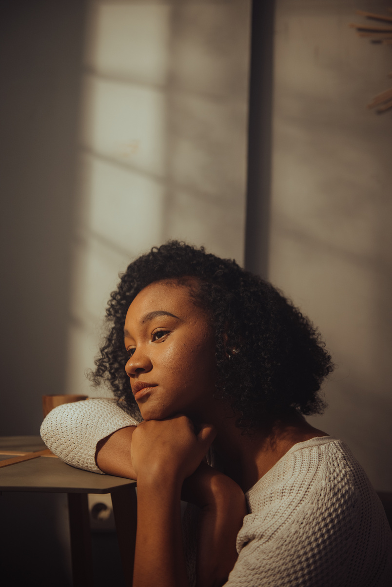 Woman Sitting in Room with Light Coming In